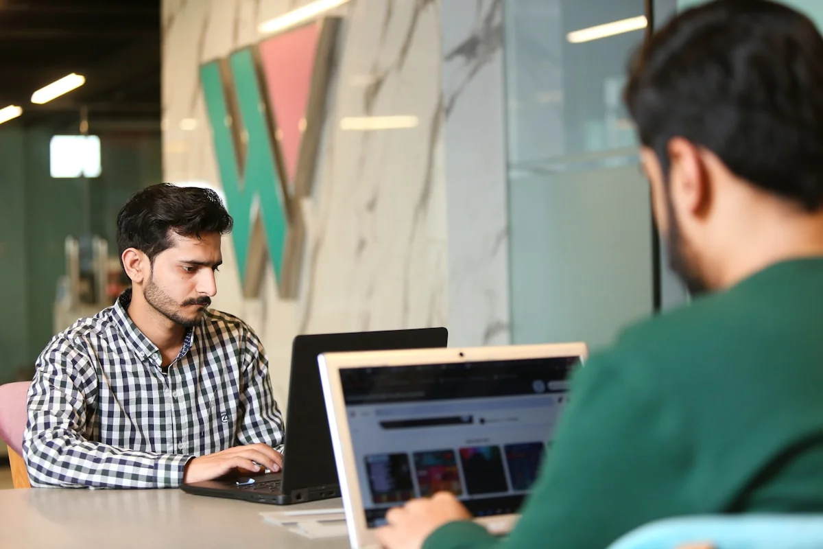 Software developers working at desks representing SaaS link building strategy
